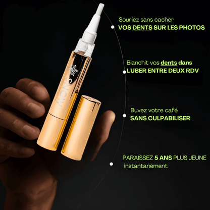 The Formula Bio Labs gold teeth whitening pen with brush applicator held against black background